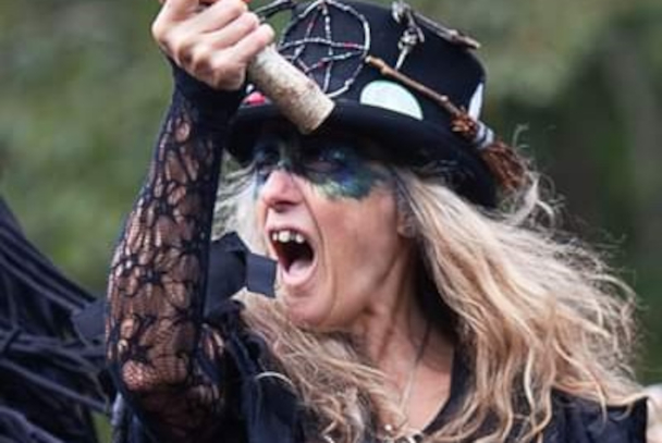A person wearing a hat and shoutinng.