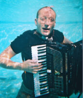 A man plays the accordion underwater.
