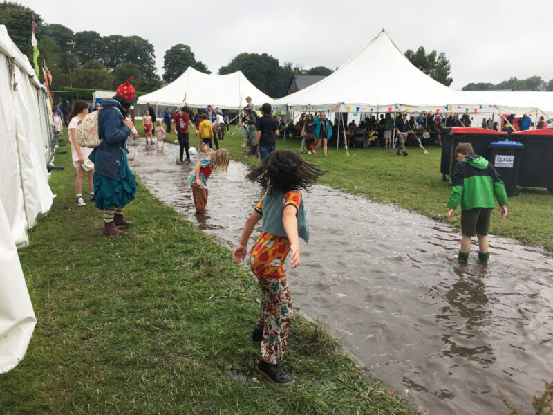 A flooded path with children playing.