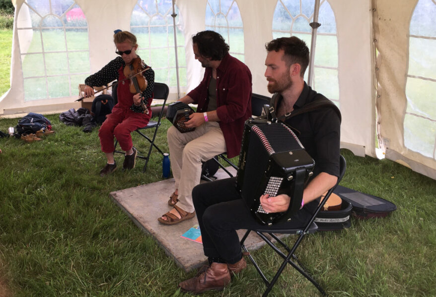 Three people playing musical instruments.