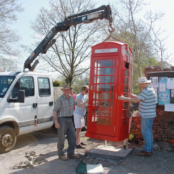 A phone box being lifted into place.