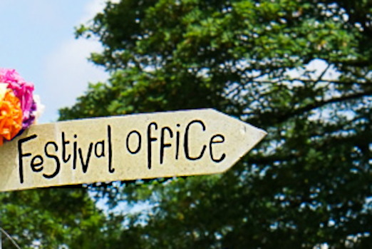 A sign pointing to the Festival Office.