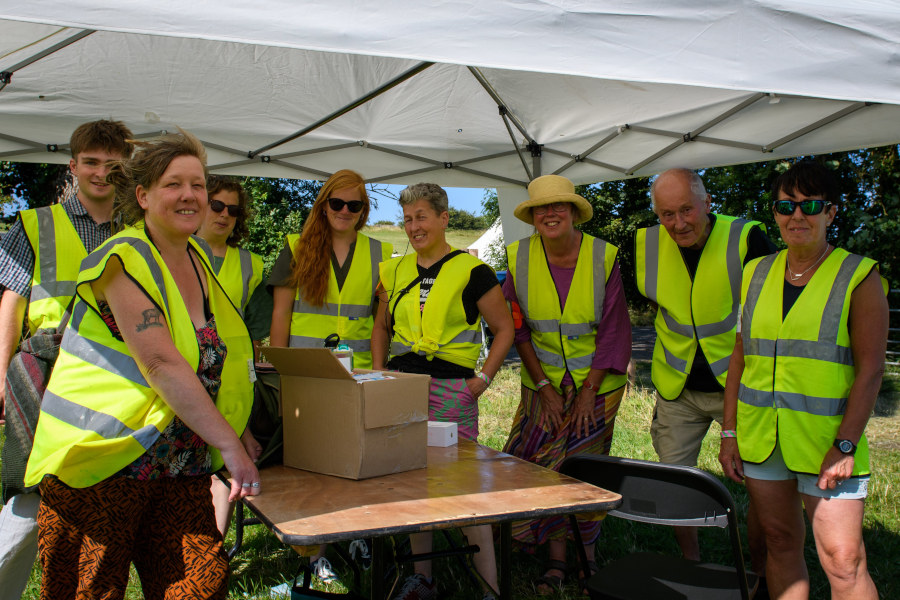 A group of people wearing bright yellow vests.