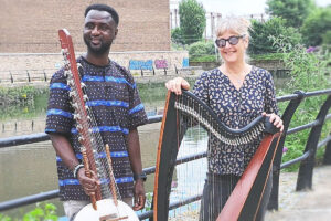A man and a woman holding musical instruments.