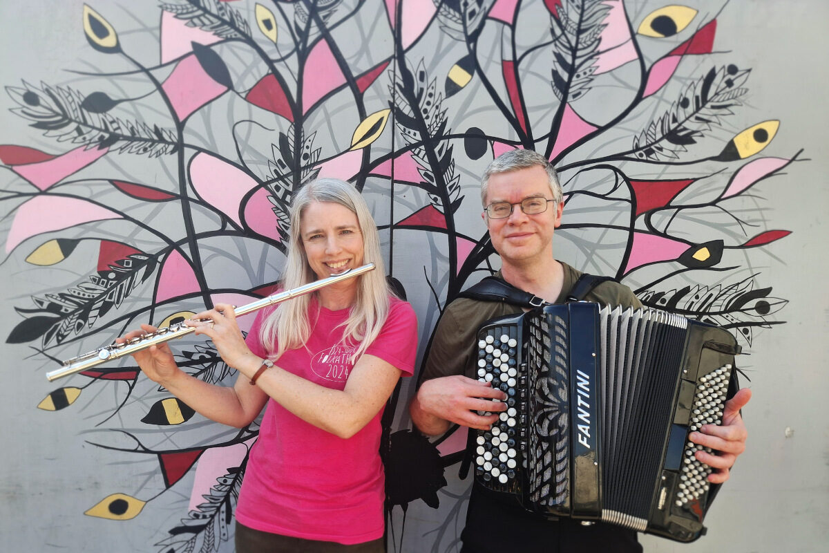 A woman with a flute and a man with an accordion.