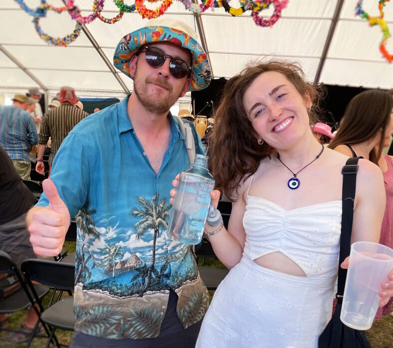 A man and a woman smiling at the camera.